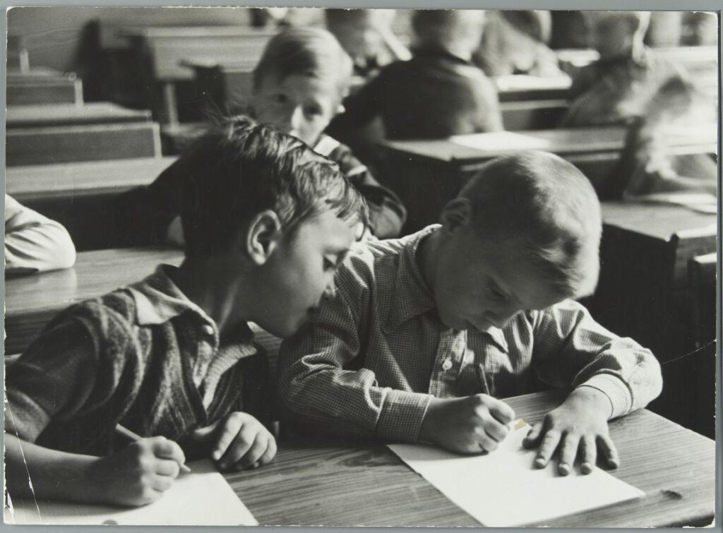 Young Dutch students in a classroom in 1937, learning how to write.